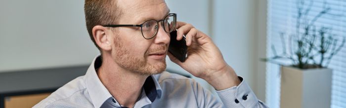 Medarbejder fra Himmerland Forsikring taler i telefon.